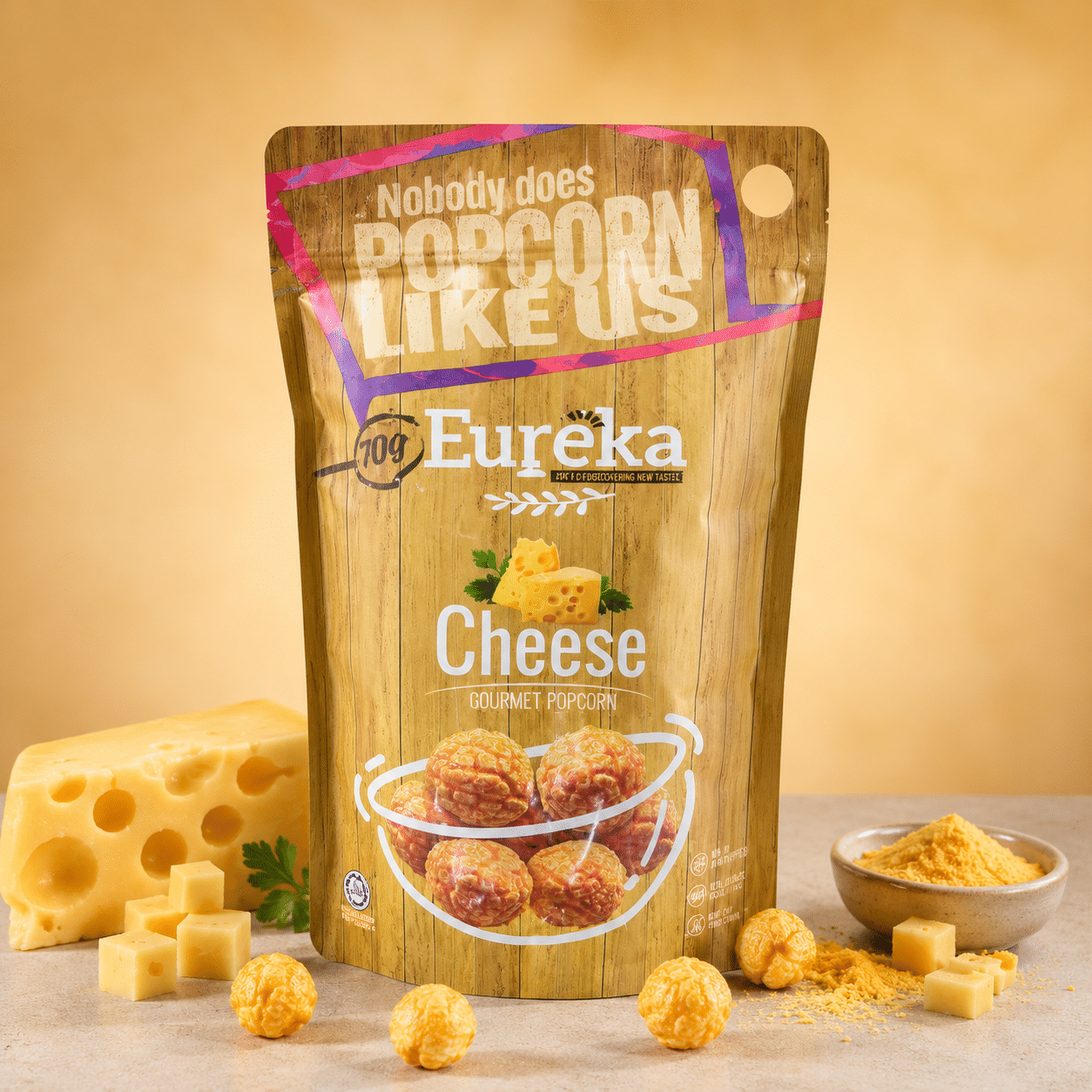 Eureka Popcorn Cheese | Snack Affair Archives Eureka Cheese Gourmet Popcorn bag on a beige surface with cheese chunks and cheese powder nearby.