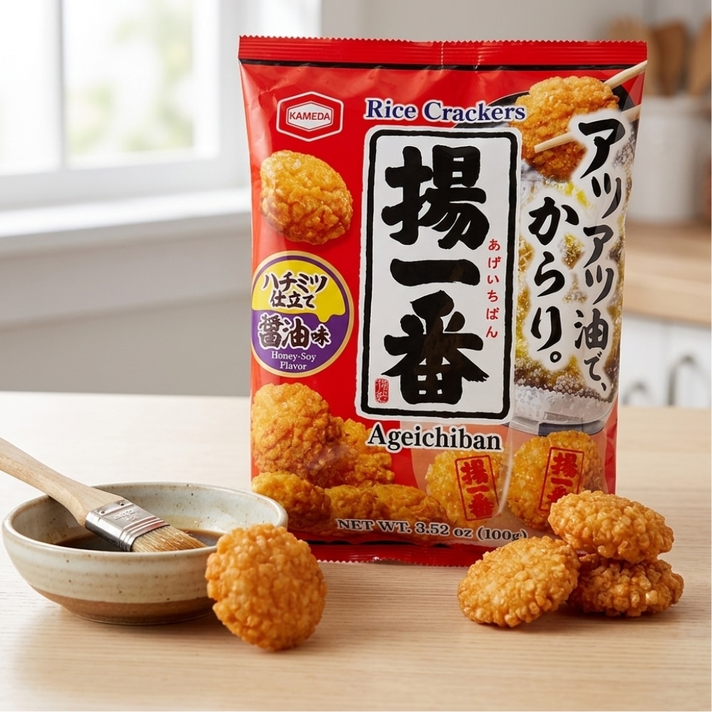 Kameda Age Ichiban rice crackers | Snack Affair Archives Red Kameda Ageichiban rice crackers bag on a table with several crispy fried bites and a small dipping bowl nearby.