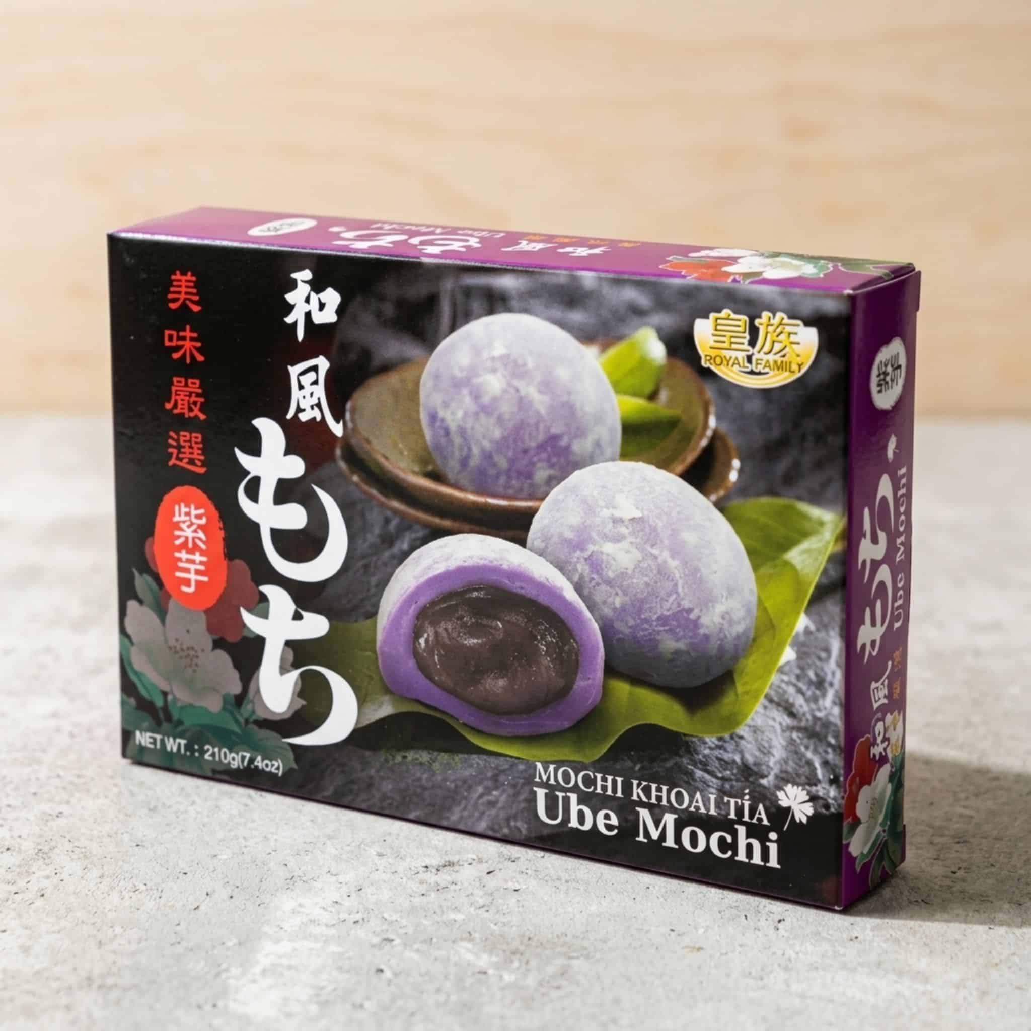 Royal Family Ube Mochi plain | Snack Affair Archives Purple and black mochi box packaging with images of purple and white mochi, side text in Japanese, and a gold seal reading 'Royal Family' on a light countertop.
