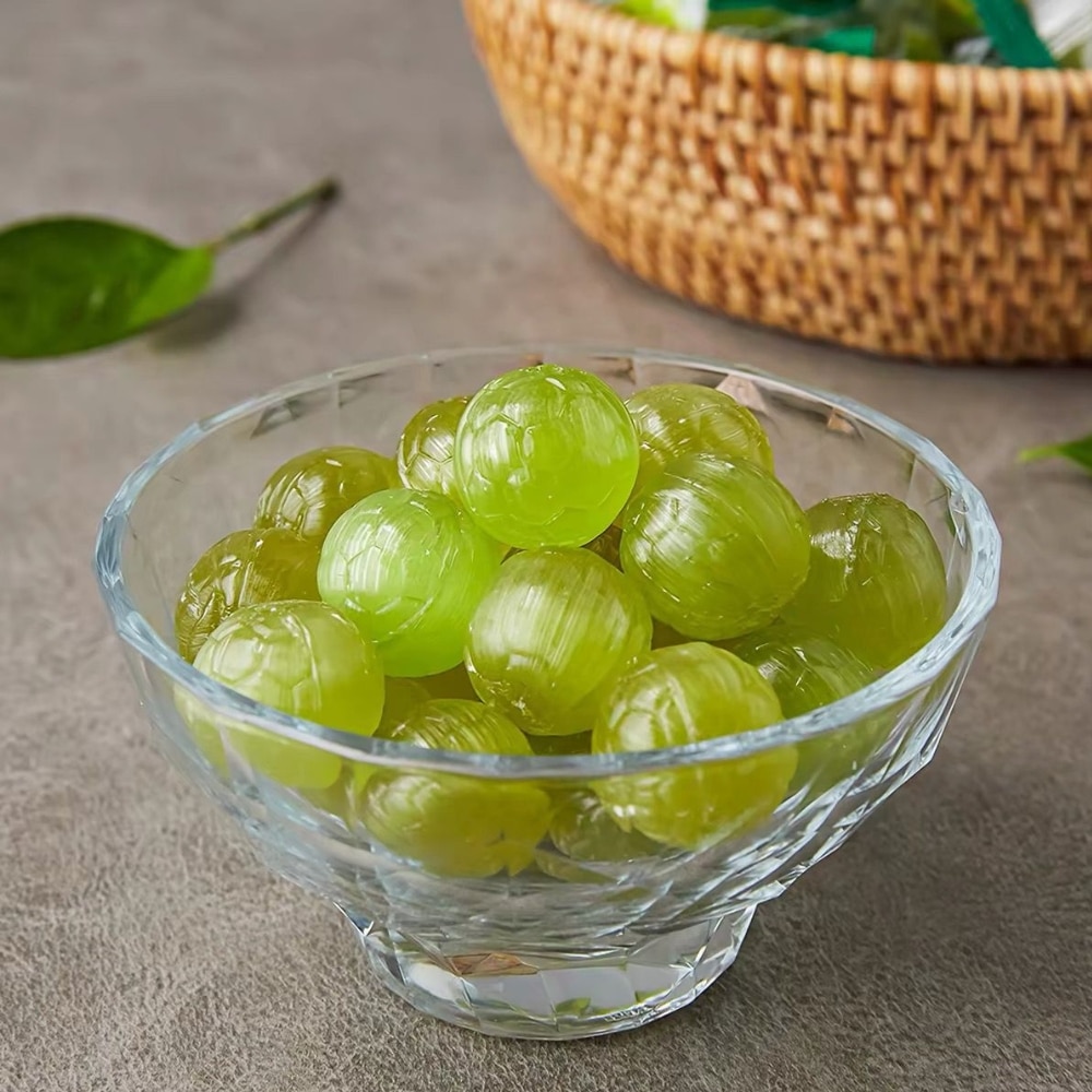 lotte green grape candy 2 | Snack Affair Archives Crystal bowl filled with bright green grapes on a textured surface