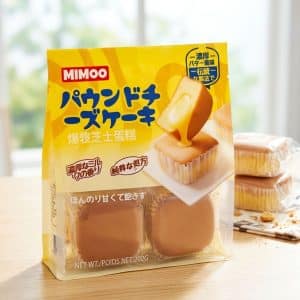Archives Bright yellow MIMO pound cake snack package with a slice cake being poured with cream artwork on the front, on a light wooden table.