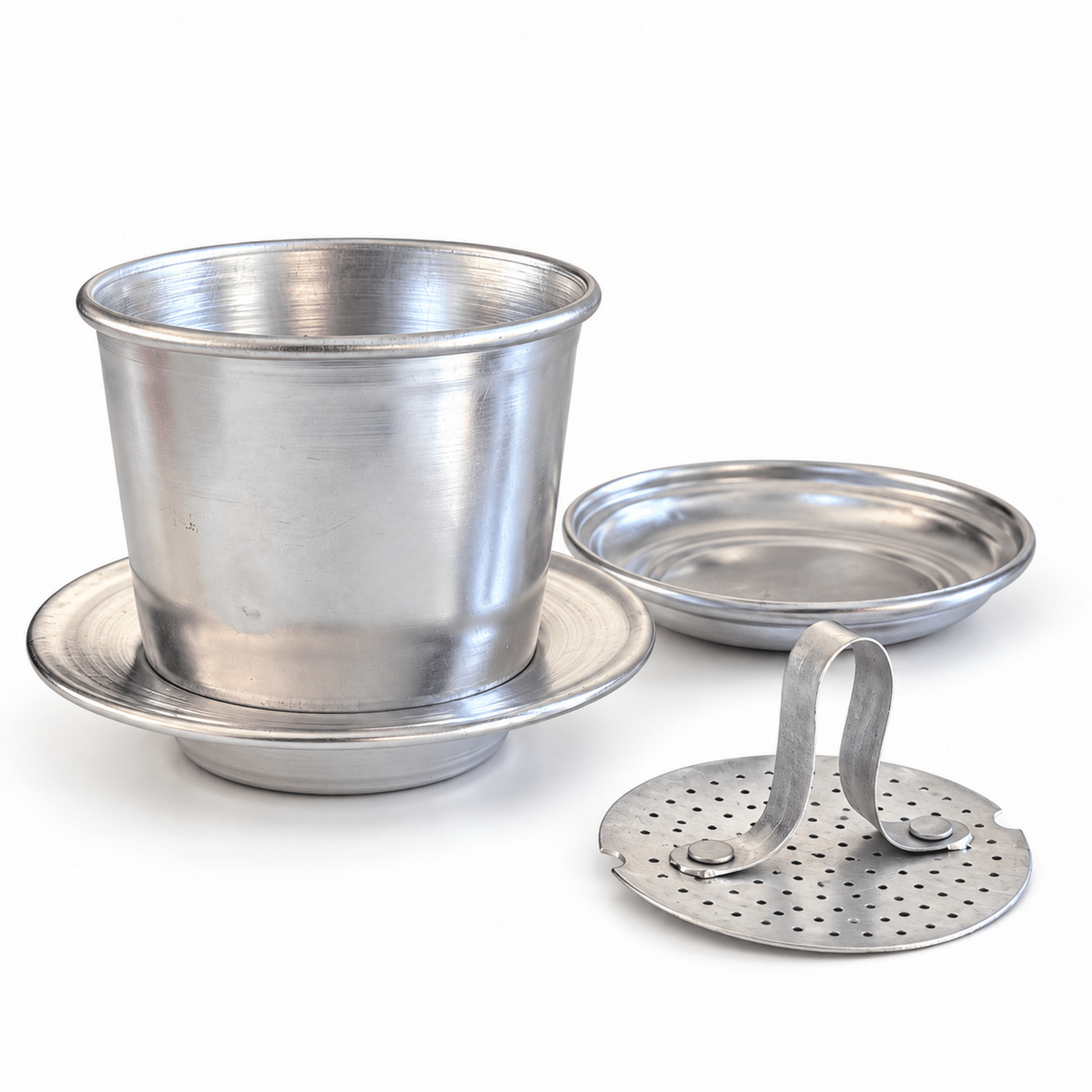 VietnameseAluminiumCoffeeFilterComponentsWhiteBackground | Snack Affair Archives Shiny metal containers with rims and a perforated lid on a white background.