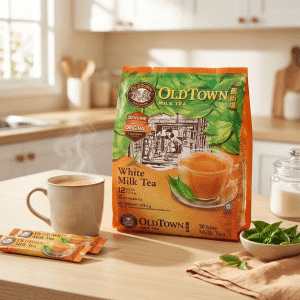Archives Box of OldTown White Milk Tea on a kitchen counter with a steaming mug nearby.