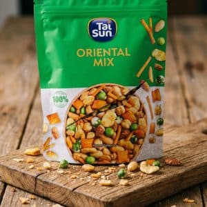 Archives Tai Sun Oriental Mix snack bag on a wooden board with mixed nuts and peas spilling around it